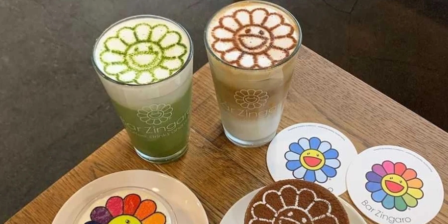 Drinks, desserts, and coasters decorated with Takashi Murakami's smiling flowers