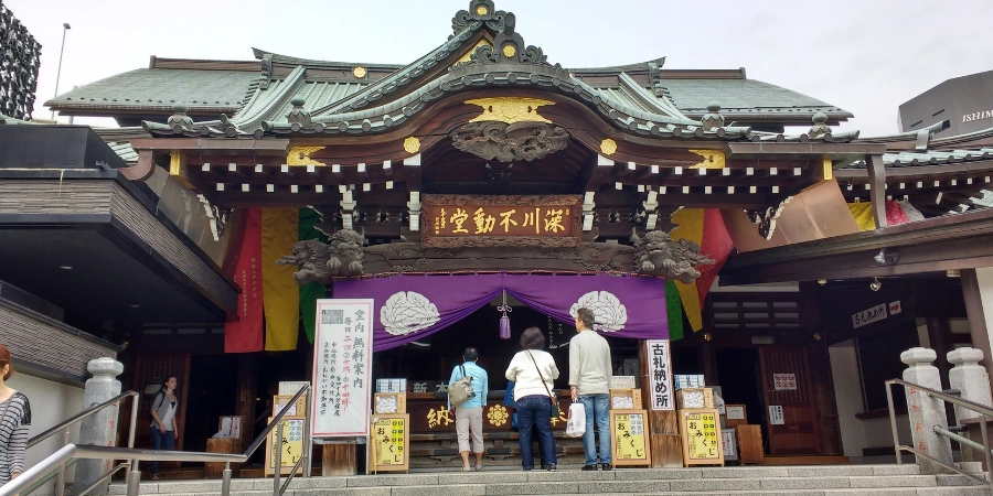 Three people praying at the temple