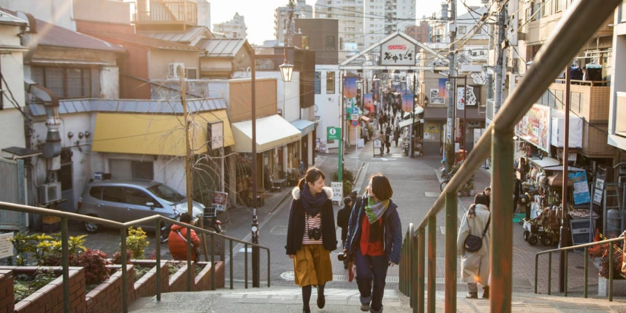 Two people chatting while going up the stairs
