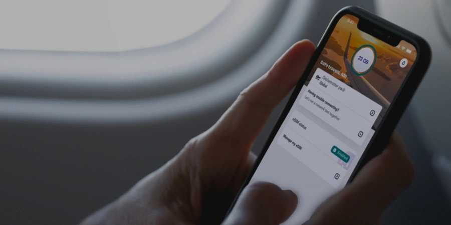 A close-up photo of a person looking at their Jetpac e-SIM plan in the airplane.
