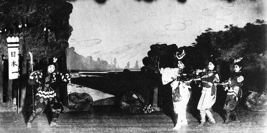 Four people performing on the stage in a black and white photo