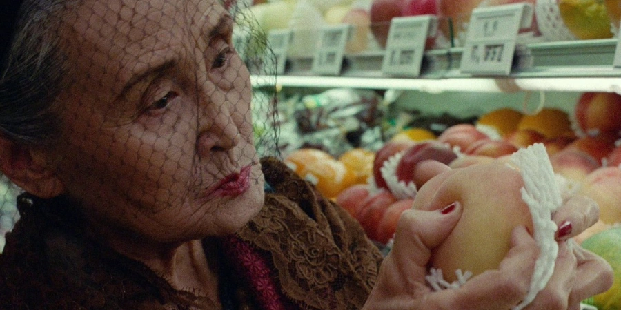 An old woman looking at the fruit (from "Tampopo)