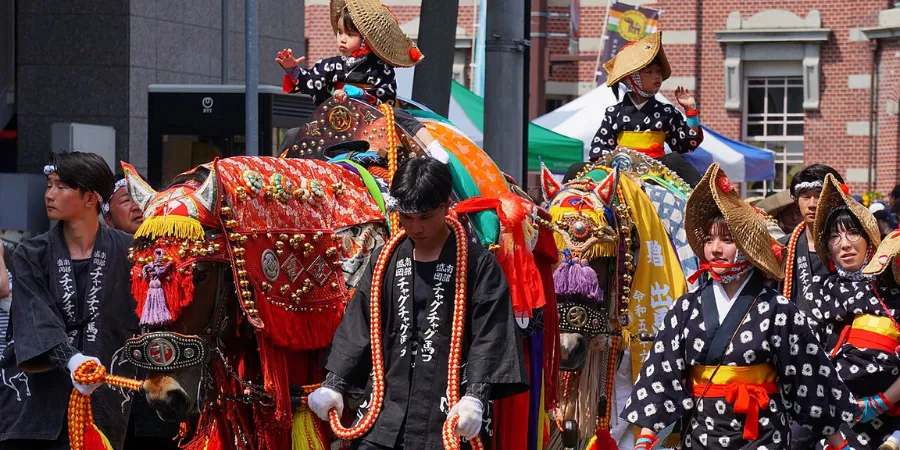Decorated horses and riders in traditional dress during the Chagu Chagu Umakko horse festival in Iwate, Japan.