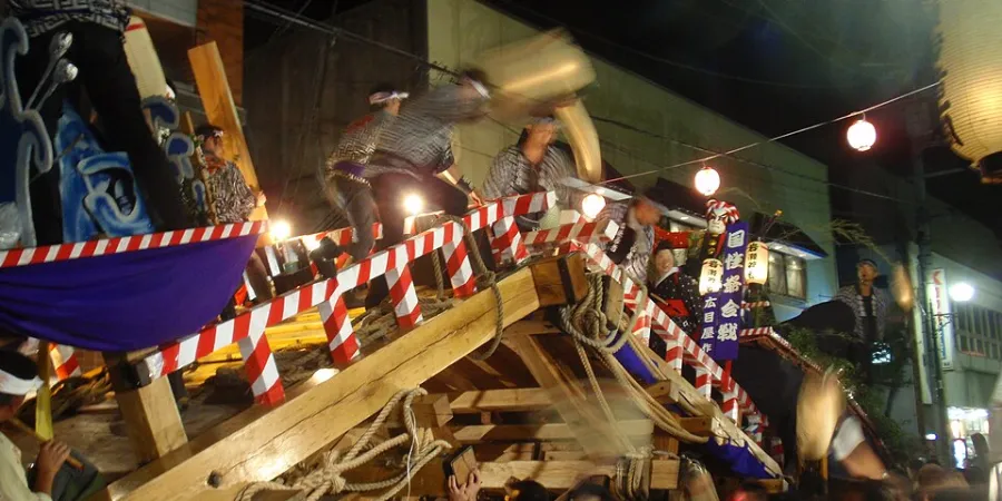 Kakunodate Matsuri in Akita, Japan, with festival performers riding a traditional wooden float during a nighttime parade