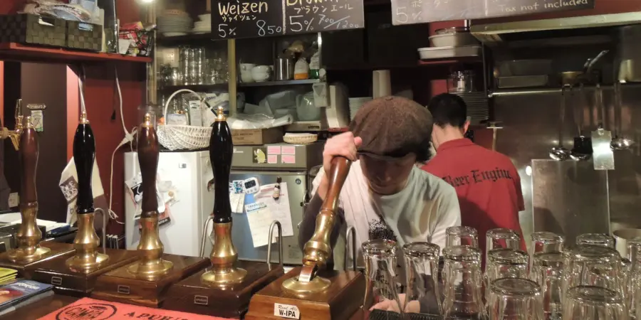 Soichiro Itsukage works one of his five hand pumps at Beer Engine in Koenji.