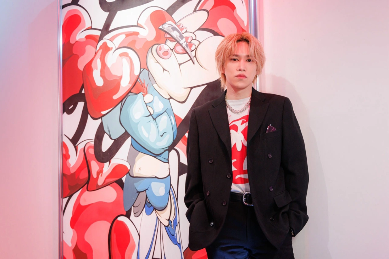 Kento Senga stands in front of his colourful FiNGAiSM artwork at the Saatchi Gallery in London, where his solo exhibition marks the European debut of the multimedia art project during FOCUS Art Fair London 2025.