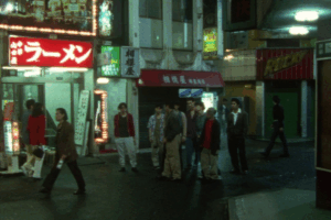 night street in koenji tokyo with ramen shop signs and people gathering reflecting indie culture nightlife and local atmosphere.