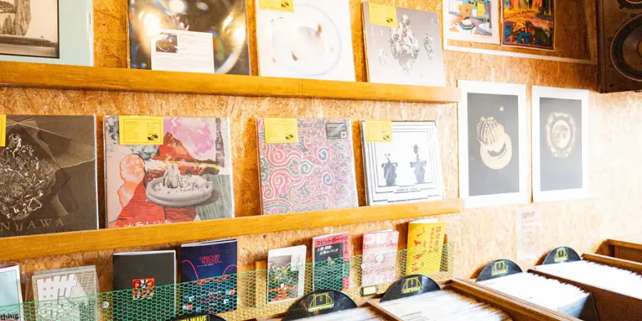 A wall display of various vintage vinyl records of different bands and musicians from various music eras.