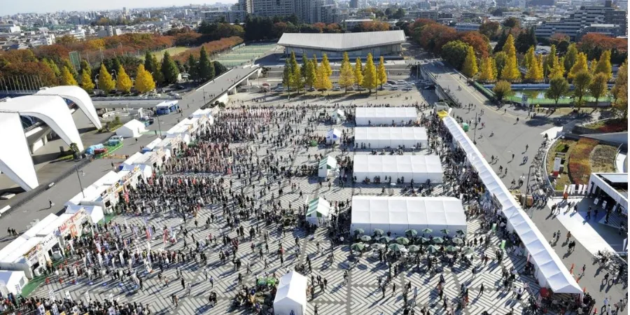 Crowds attending Tokyo Ramen Festa food festival with ramen stalls and event tents in Tokyo, Japan