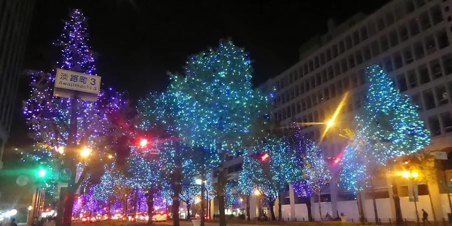 Trees illuminated with blue and purple lights along Midosuji Avenue in Osaka at night