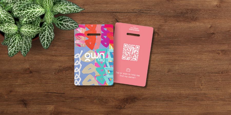 Two colorful digital luggage or keychain tags, labeled "own tag," featuring a QR code for tracking lost items.