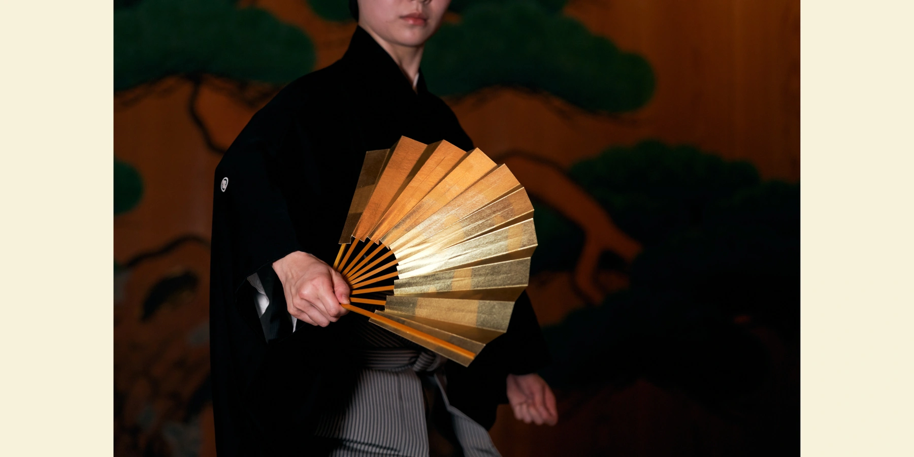 Noh actor on-stage, with half his face concealed