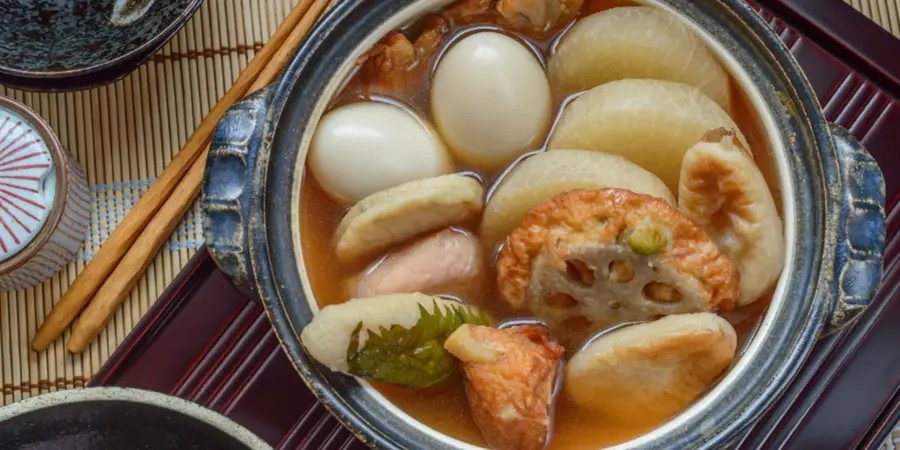 A bowl of oden, soup filled with various Japanese vegetables and hard-boiled eggs