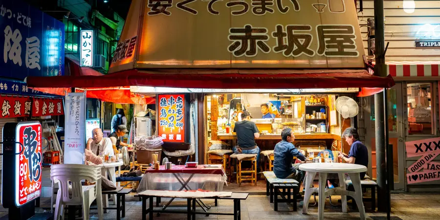 An open-door restaurant by a corner street in Shinsekai