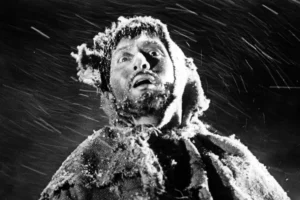 A low angle dramatic close up of Kaji with a look of terror and exhaustion as he collapses in the snow during the final scenes of A Soldiers Prayer.
