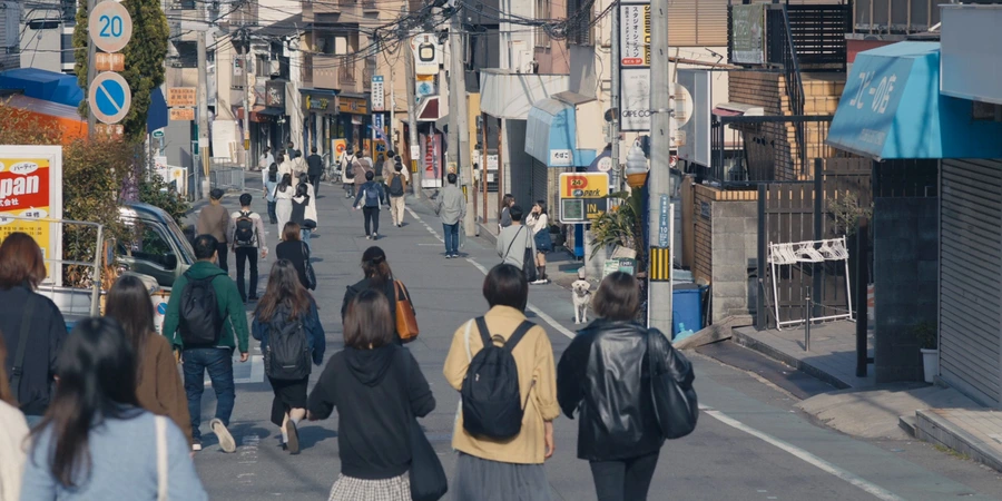 Various people walking down a street in Japan.