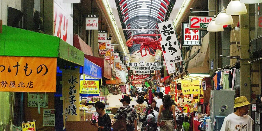 A shopping arcade in Namba that sells various items like clothes, snacks, and souvenirs