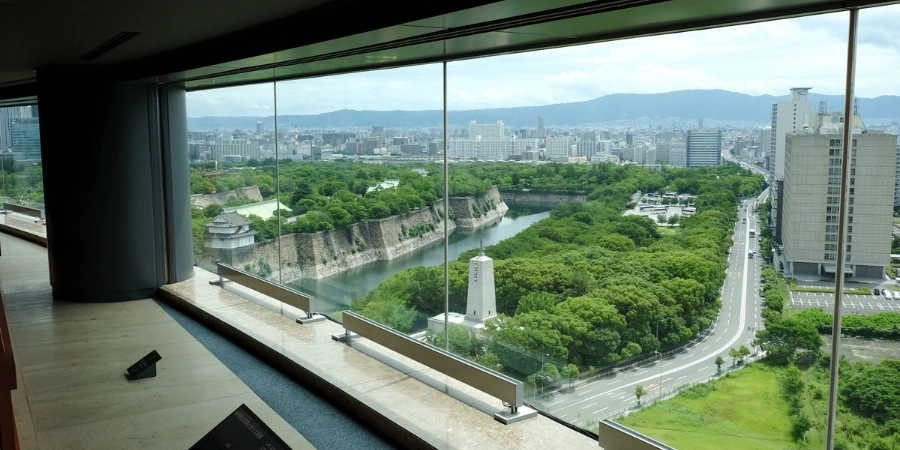 Expansive 10th-floor panoramic view from Osaka Museum of History overlooking central Osaka skyline and Osaka Castle, highlighting the museum's prime vantage point for ancient Naniwa exhibits.