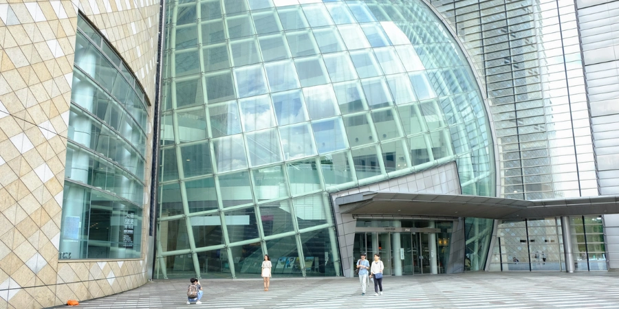 Modern glass-globe entrance to the Osaka Museum of History, welcoming visitors to its chronological exhibits on Osaka's 1,400-year history near Osaka Castle Park.