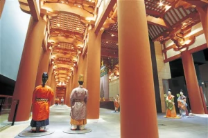 Recreated ancient palace corridor inside Osaka Museum of History with tall red pillars and mannequins in traditional Japanese court attire