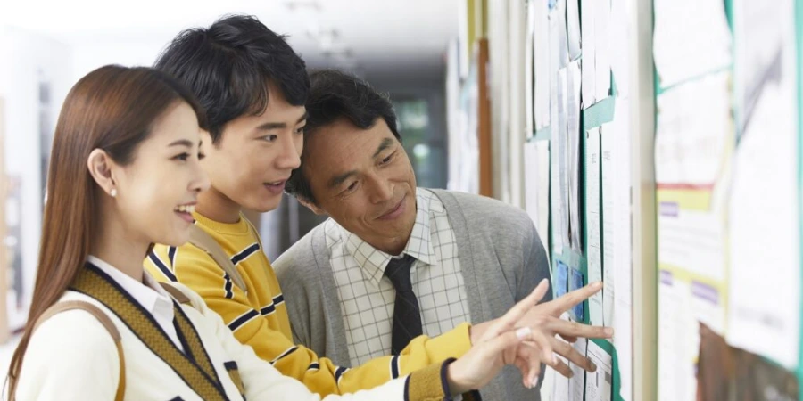 Students looking at postings on a bulletin board