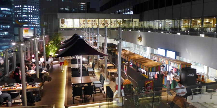 Lush outdoor terrace garden on the 14th floor of Daimaru Umeda department store, with greenery, seating, and panoramic city views from Osaka Station City.