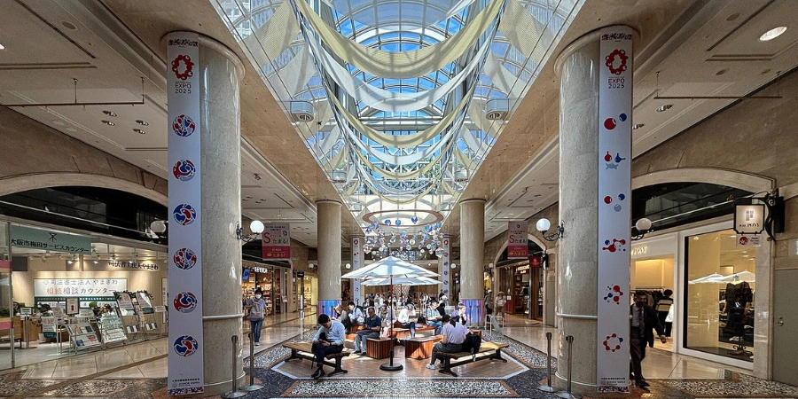 Modern exterior of Diamor Osaka shopping complex in Umeda, showcasing Italian-inspired architecture with brick facades and glass entrances in June 2025.