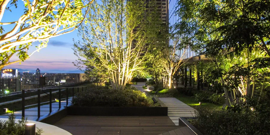 Rooftop Terrace Garden atop Grand Front Osaka North Building in 2013, featuring greenery, seating areas, glass railings, and panoramic city skyline views.