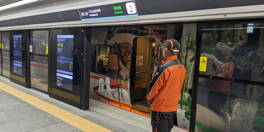 Platform-level view at Umekita Station near Grand Front Osaka, featuring sleek platform screen doors, signage, and modern rail infrastructure.