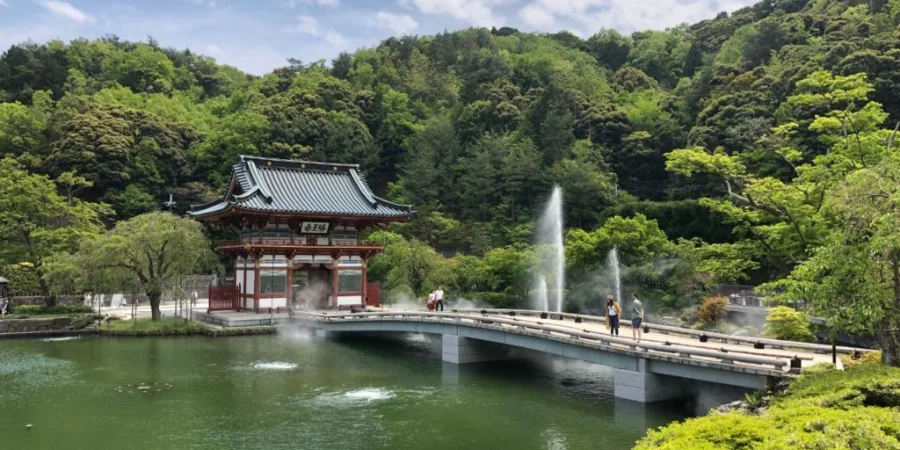 Katsuoji Temple with a red bridge over a pond, traditional architecture, and landscaped gardens in Osaka, Japan