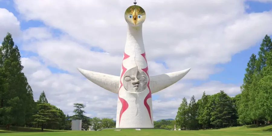 Tower of the Sun sculpture at Expo ’70 Commemorative Park in Osaka, surrounded by open green lawns and trees
