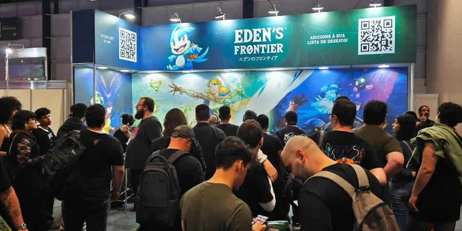 Crowd gathered at the Eden’s Frontier booth during BGS 2025 gaming expo, with attendees watching a live demo and large anime fantasy game banner display in the background.