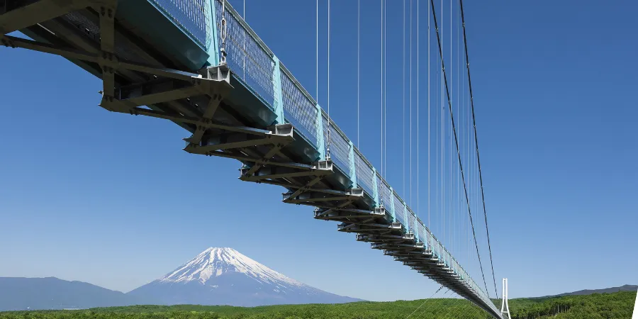 Mishima Skywalk suspension bridge with Mount Fuji visible in the distance in Shizuoka, Japan
