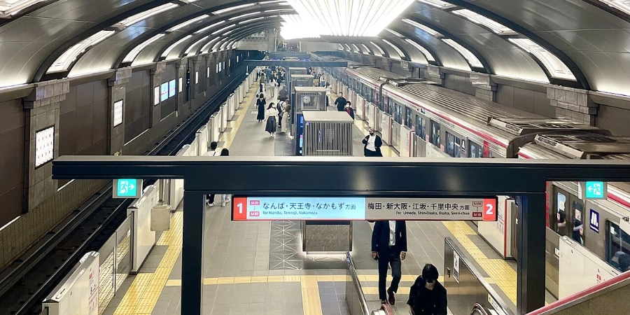 Interior of Shinsaibashi Station Osaka showing subway platforms and passengers on the Osaka Metro