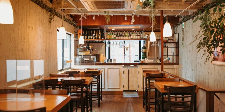Cozy interior seating area inside The Roasters Coffee in Shinsaibashi Osaka with wooden décor and café tables