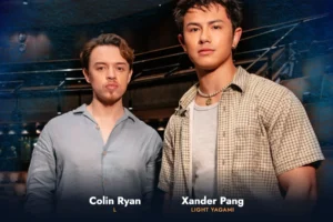 Two actors announced for Death Note: The Musical: Colin Ryan as L and Xander Pang as Light Yagami, standing side by side in casual clothing against a dark indoor backdrop.