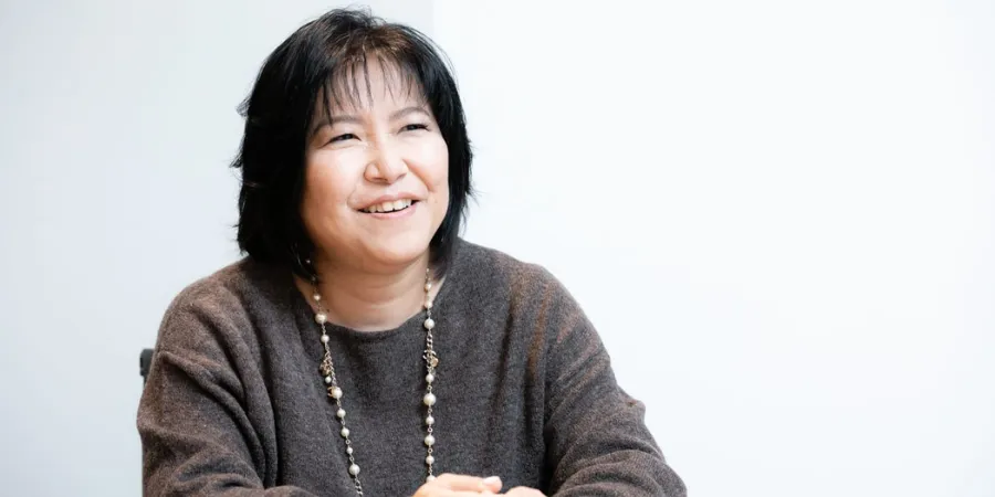 Yoko Shimomura smiling during an interview, suitable for content about Square Enix soundtracks, Kingdom Hearts music, and video game composition.