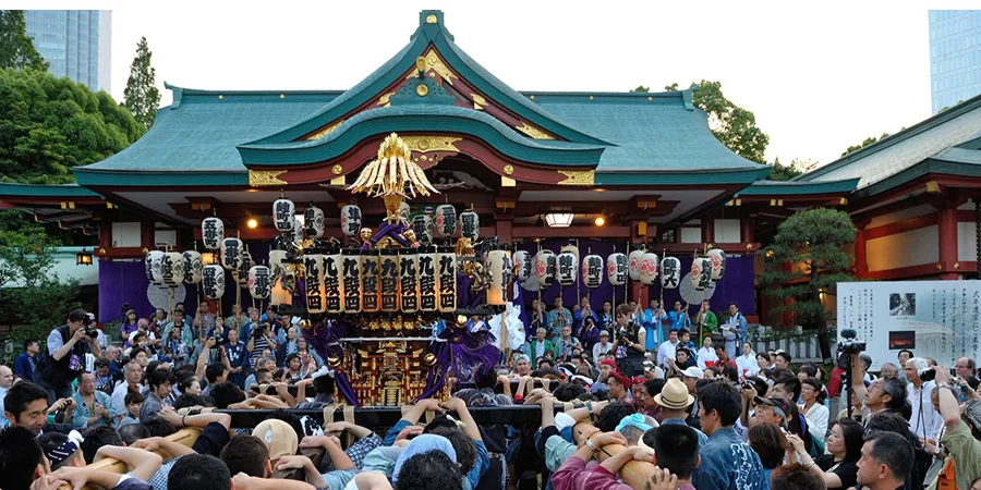 Crowds carrying a mikoshi shrine during the Sanno Matsuri festival in Tokyo, Japan.