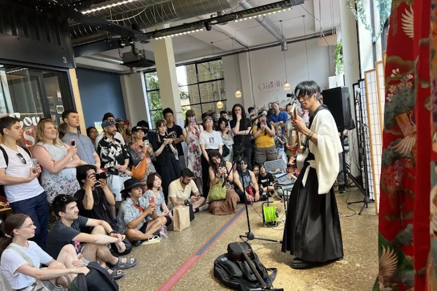 Visitors attending the Yokimono Japanese Market in Dalston, London, with a live traditional Japanese music performance and cultural festival atmosphere