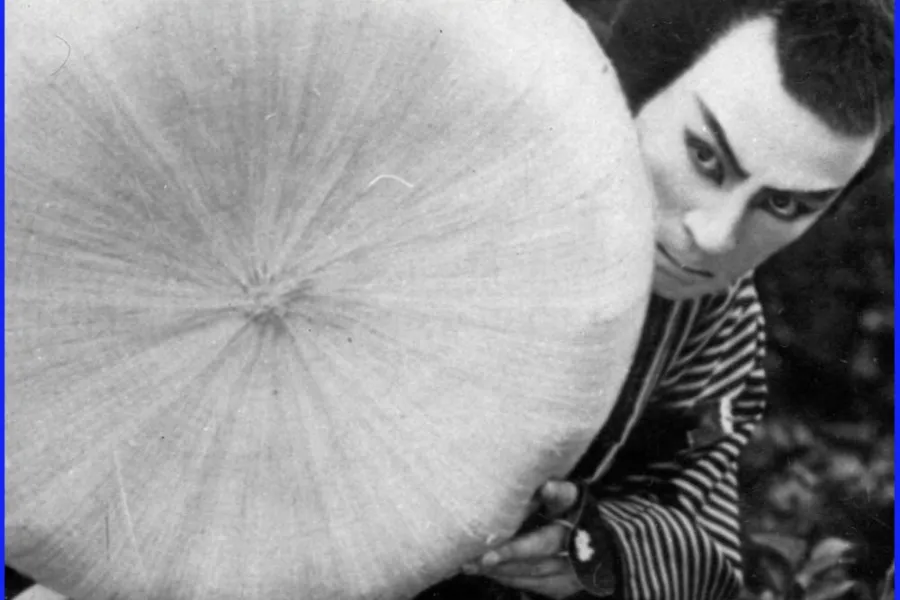 Black-and-white promotional image for 100 Years of Japanese Cinema featuring a dramatic figure holding a traditional Japanese paper umbrella, representing the history and evolution of Japanese cinema and classic Japanese film culture.