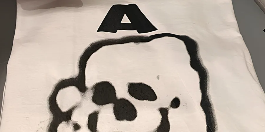 Close-up of an A BATHING APE (BAPE) A-Bomb graphic T-shirt featuring the iconic ape skull spray-painted print.