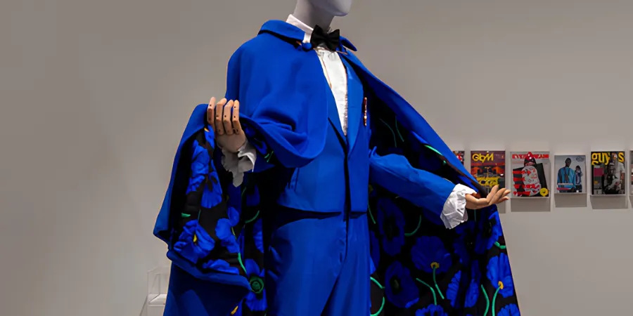 Kid Cudi's 2022 Met Gala royal blue tuxedo and floral-lined cape designed by Kenzo, displayed on a mannequin.