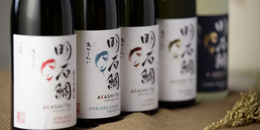 Akashi-Tai Japanese sake bottles displayed in a row, including Honjozo Genshu sake
