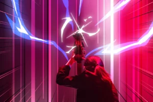 Double bass player performing during The Sound of Epic Anime concert, framed by vivid red, pink and white anime-inspired stage lighting.