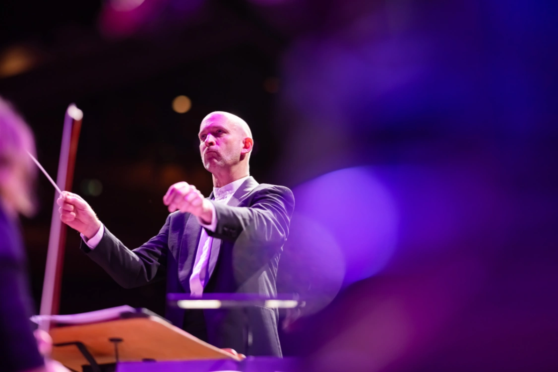 Michael England conducting an orchestra during The Sound of Epic Anime concert