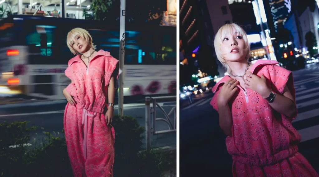 Nao Yoshioka wearing a bright pink outfit during a night-time photoshoot on a city street.