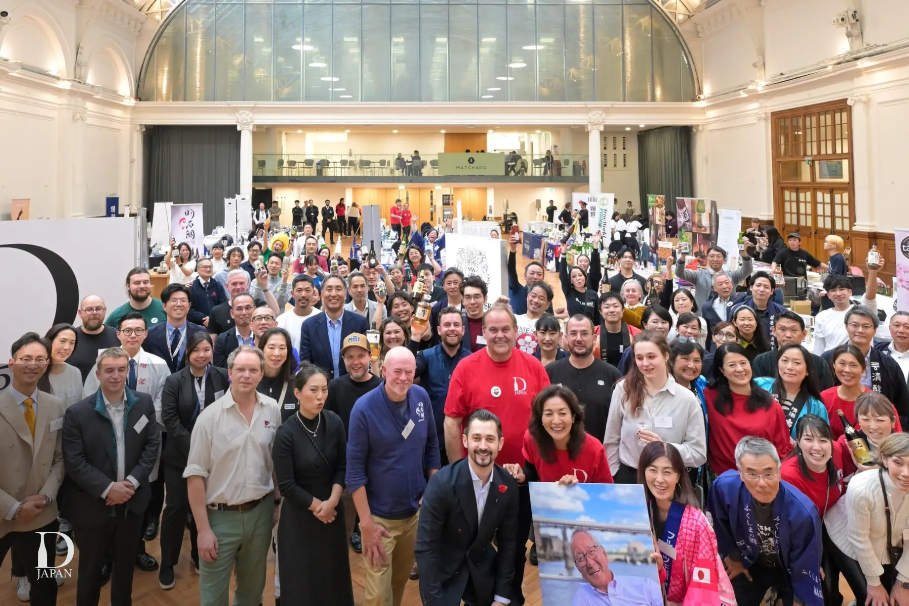 Exhibitors, organisers and guests gather for a group photo inside Lindley Hall during Drink Japan, the London event celebrating Japanese drinks, food and culture.