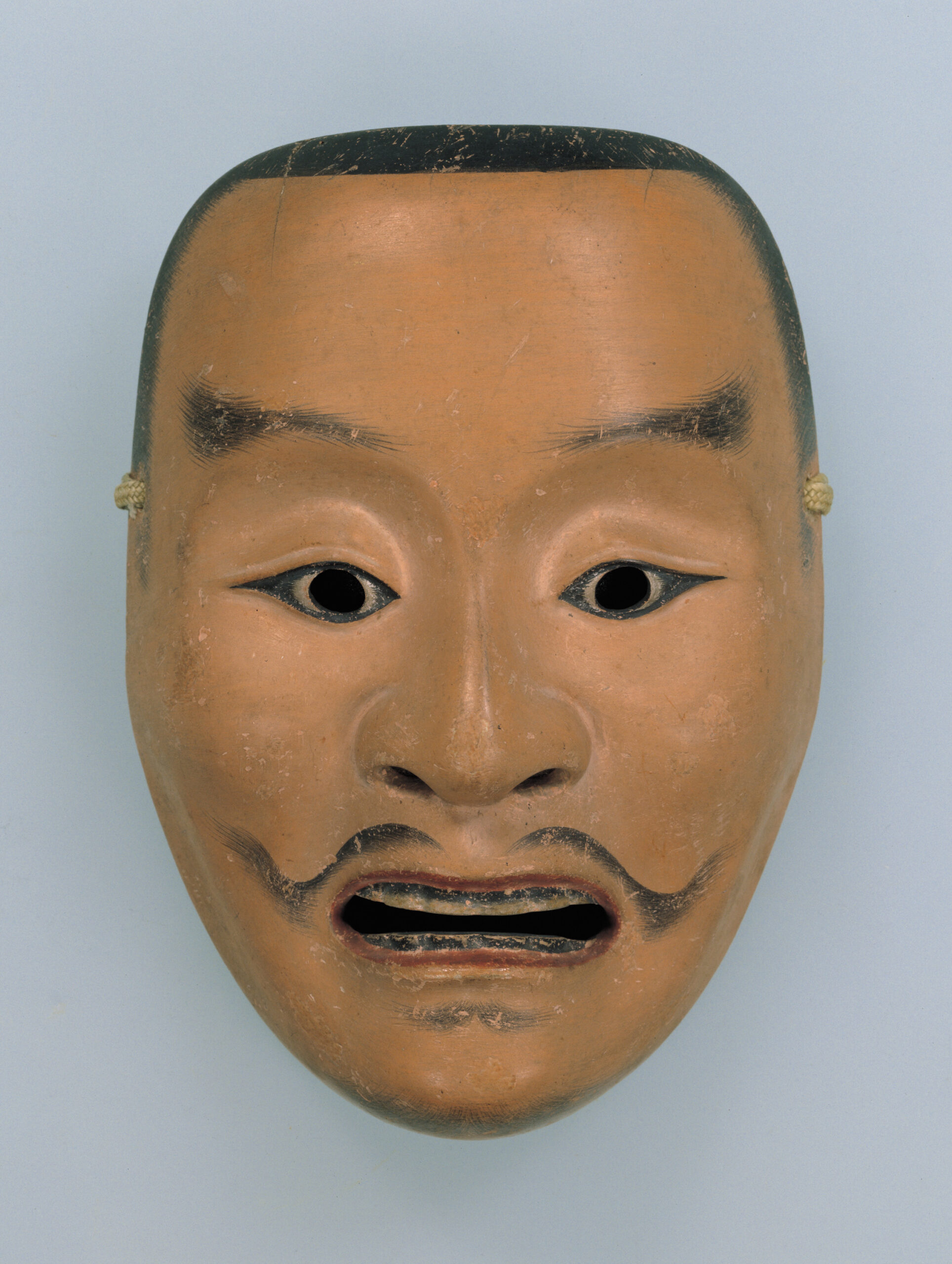 A Heita Noh mask, the face of a seasoned warrior, held by the Tokyo National Museum.