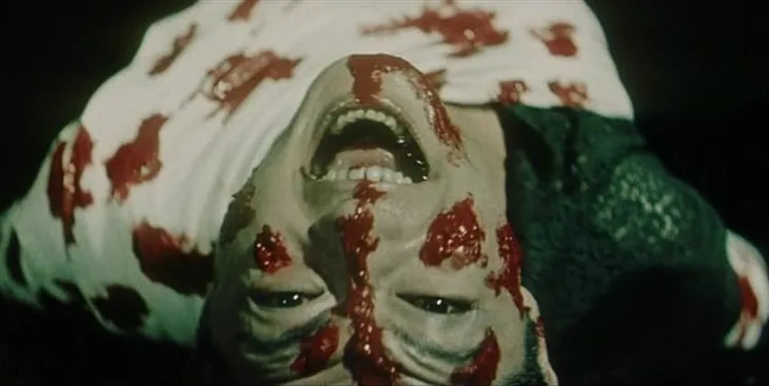 A blood covered face inverted in the hell sequences of Nobuo Nakagawa's Jigoku.