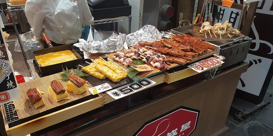 Grilled seafood and Japanese street food at a food stall in Kuromon Ichiba Market, Osaka